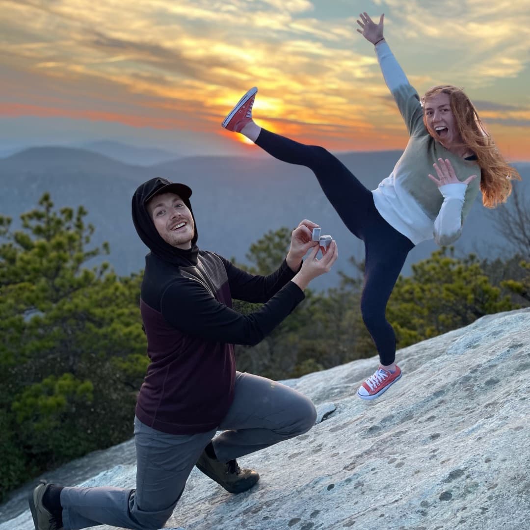 Rose jumps for joy at their engagement on Hawksbill Mountain.