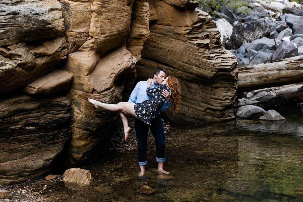 Rose and Reid share a smooch under the sandstone walls of Oak Creek Canyon.